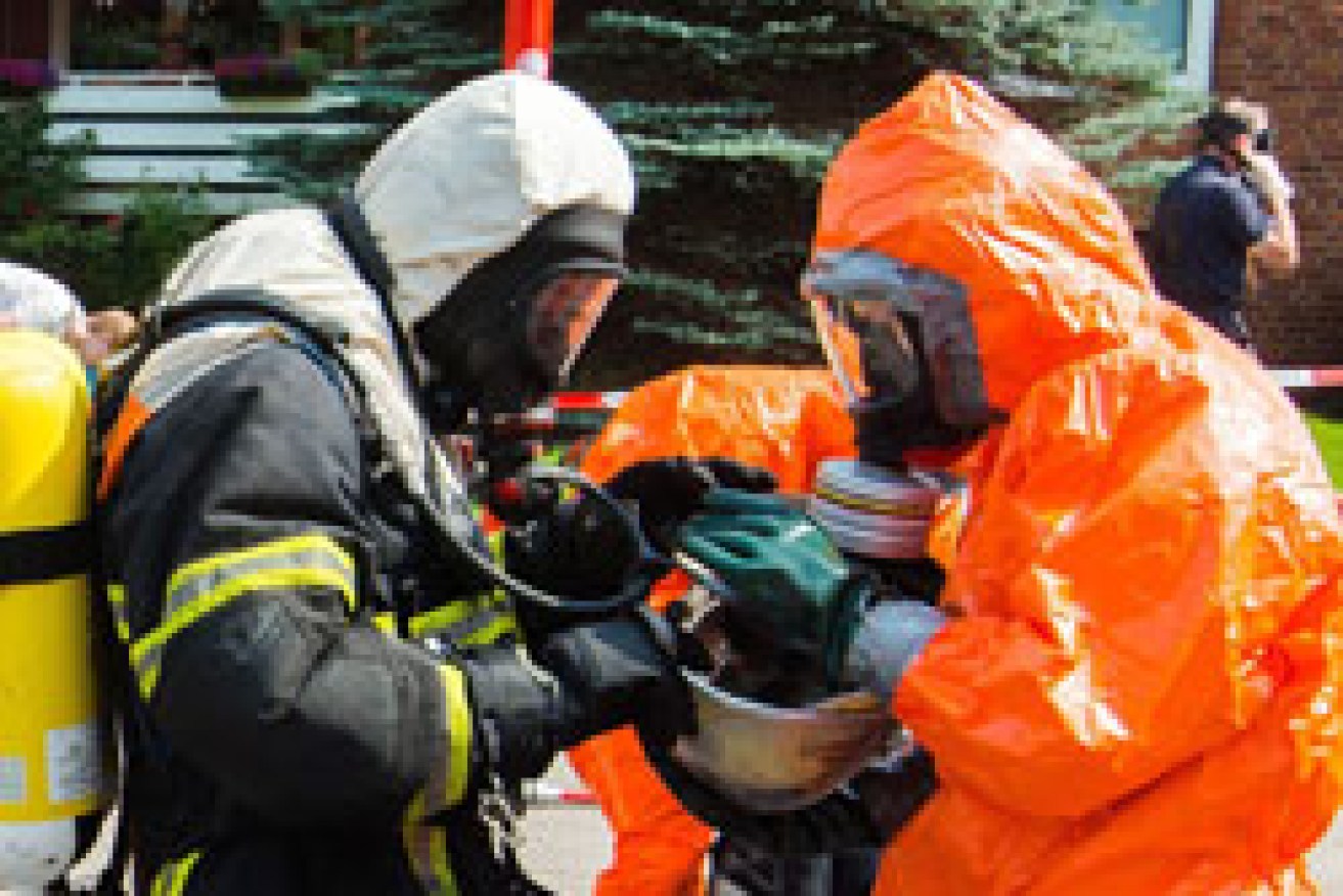 Firefighters are decontaminated. Photo: AAP