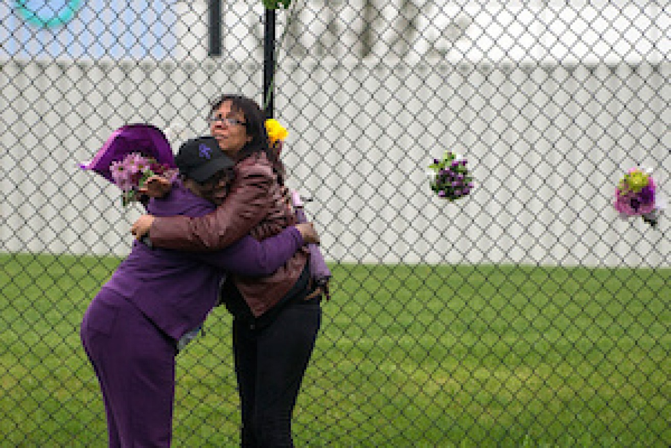 Mourners embrace outside Paisley Park. Photo: Getty