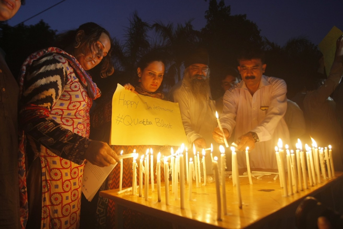 Pakistani civil society activists light candles to pay tribute to victims of the Quetta bombing. 