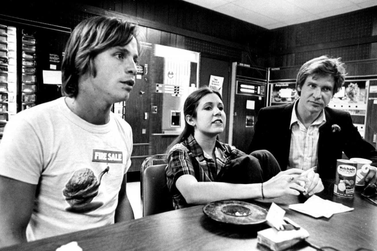 Carrie Fisher in 1977 with her <i>Star Wars</i> co-stars Mark Hamill (left) and Harrison Ford (right).