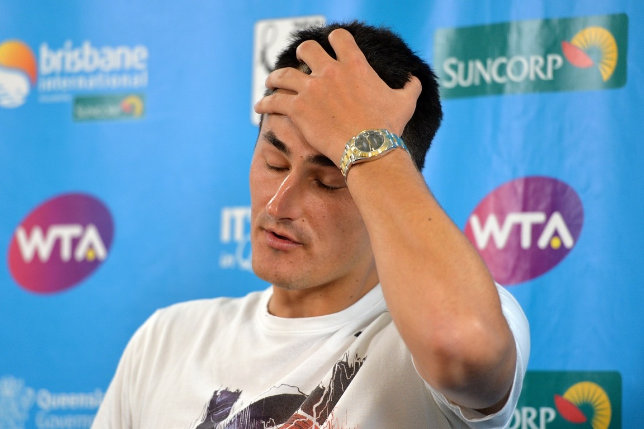 Bernard Tomic reacts in the press conference following his first-round loss in Brisbane.