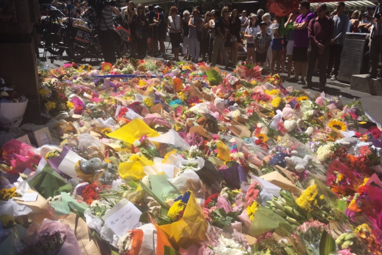 Hundreds of flowers, teddy bears were laid in tribute to the Bourke St victims. Photo: Twitter.