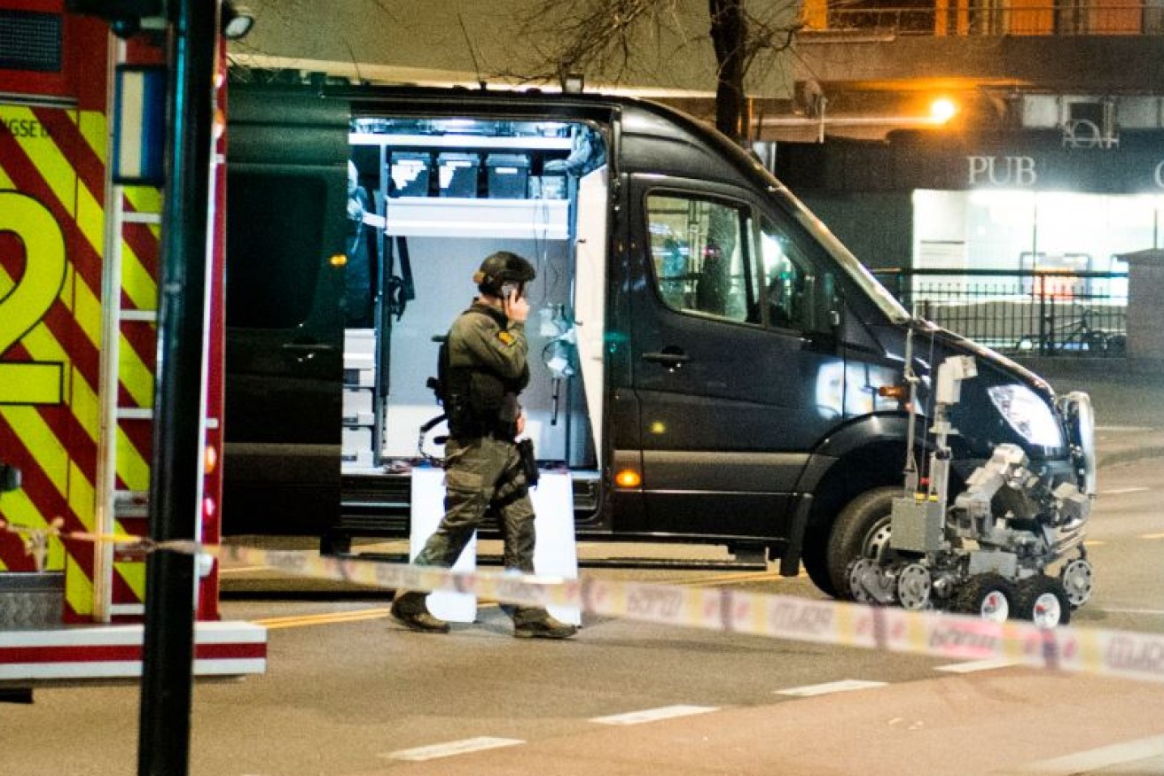 A Norwegian bomb-disposal officer wheels out the robot used to detonate the bomb in Oslo's nightlife district.
