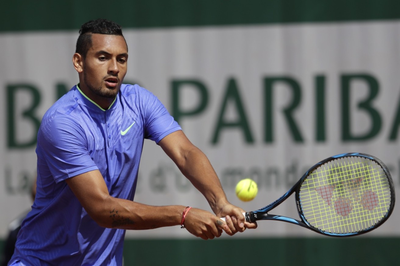 Nick Kyrgios moves through to the French Open second round in straight but not without an argument.