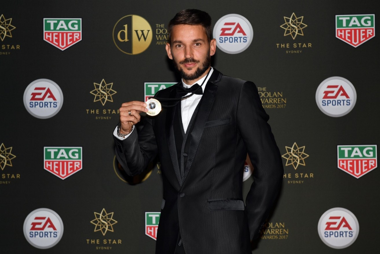 A-League player Milos Ninkovic poses with the Johnny Warren Medal.
