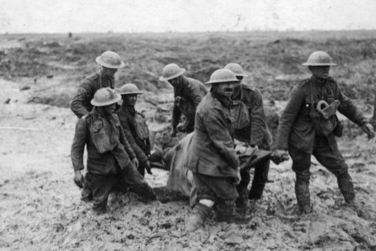 Knee-deep in sucking mud, a stretcher party carries one of the tens of thousands of dead and wounded from the hell of Passchendaele.