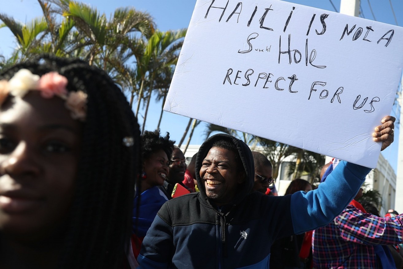 Haitians protest outside Donald Trump's Florida retreat over his comments about their country.