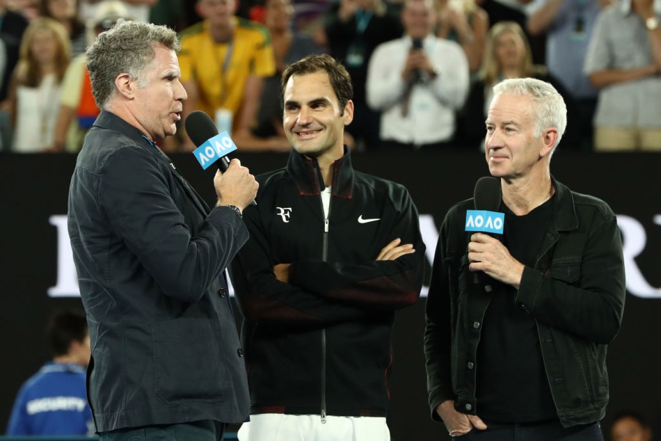 Will Ferrell (L) and John McEnroe (R) 'interview' Roger Federer after his opening match. 
