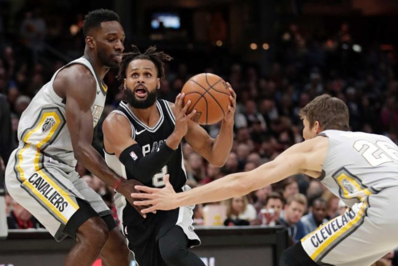 Patty Mills drives for San Antonio Spurs in a game against the Cleveland Cavaliers.