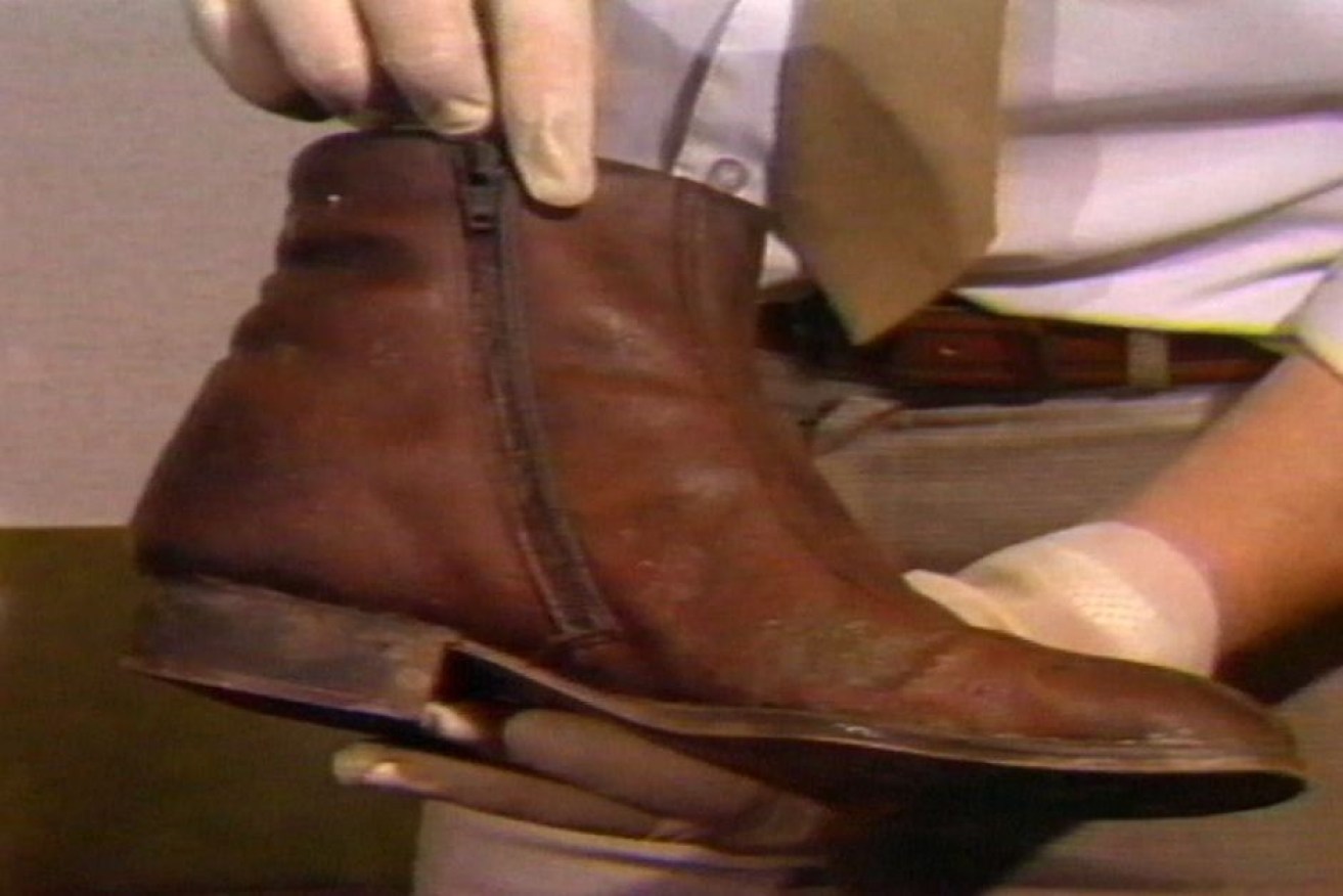 Police display the boot found on the leg in Launceston's Tamar River in 1984.