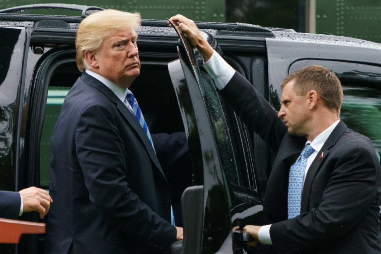 A scowling Donald Trump heads back to the White House after a hospital visit with wife Melania, whose name he later misspelled. 
