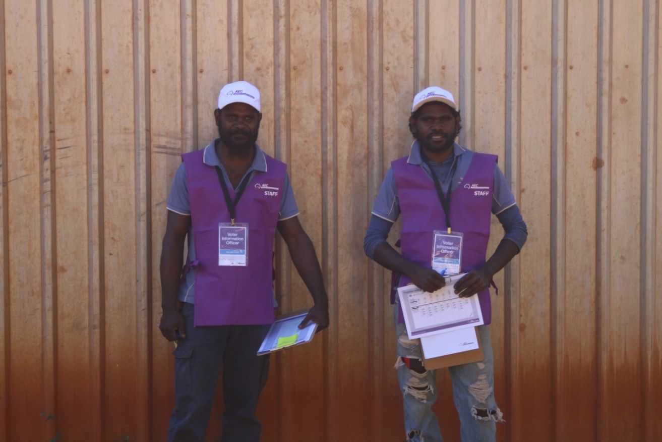 AEC volunteer information officers Esau and Jerry Martin prepare to help locals with the voting process at Bulman community in central Arnhem Land in 2016. 