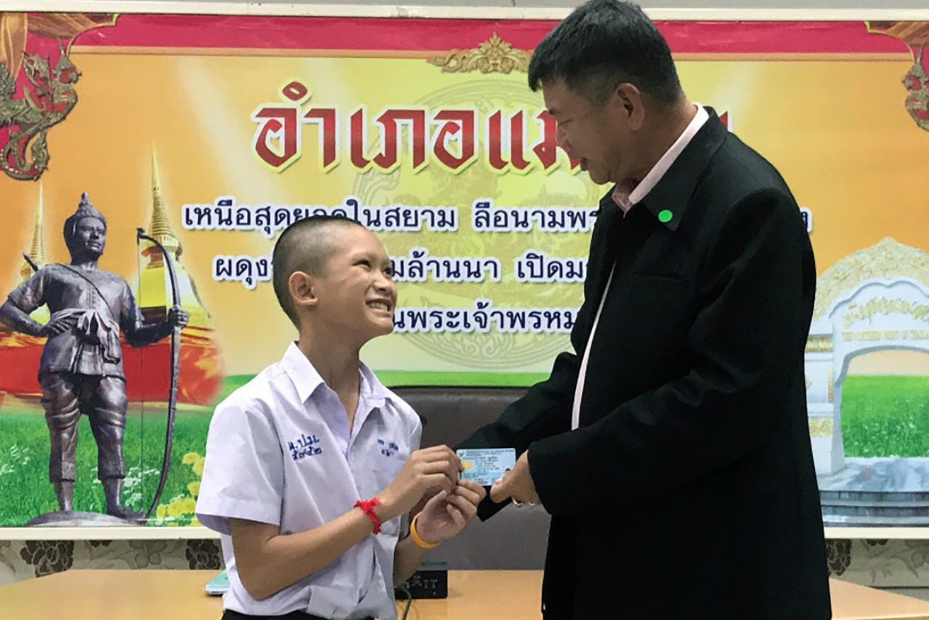 Wild Boar soccer team Mongkol Boonpiam receives his Thai citizen ID card.