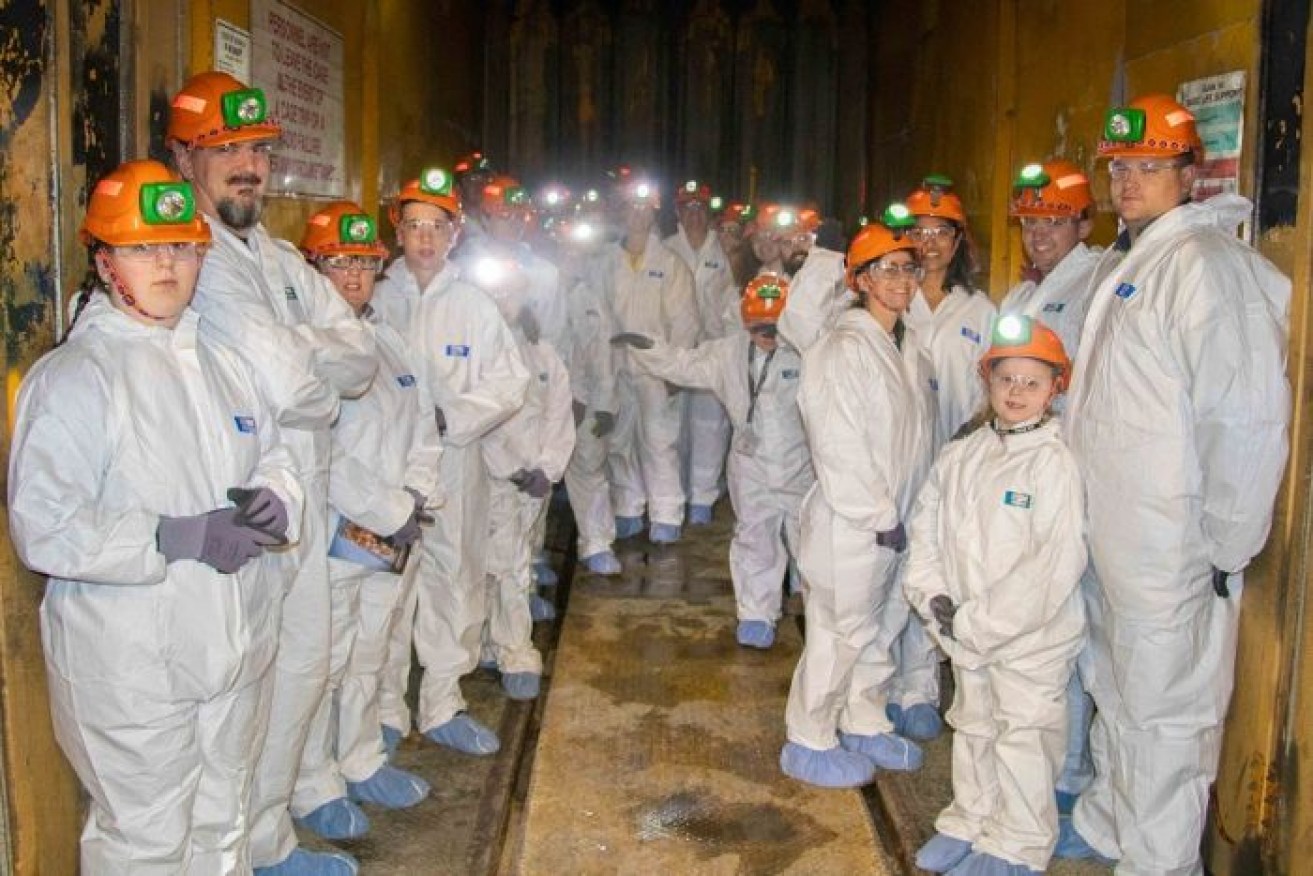 A group of mining families checking out the underground tunnels of the George Fisher mine at Mount Isa.