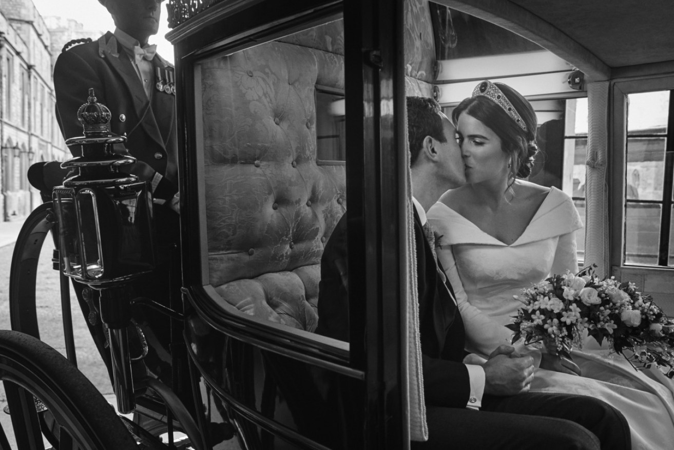Britain's Princess Eugenie of York and Jack Brooksbank embrace in the Scottish State Coach after the weddding. 