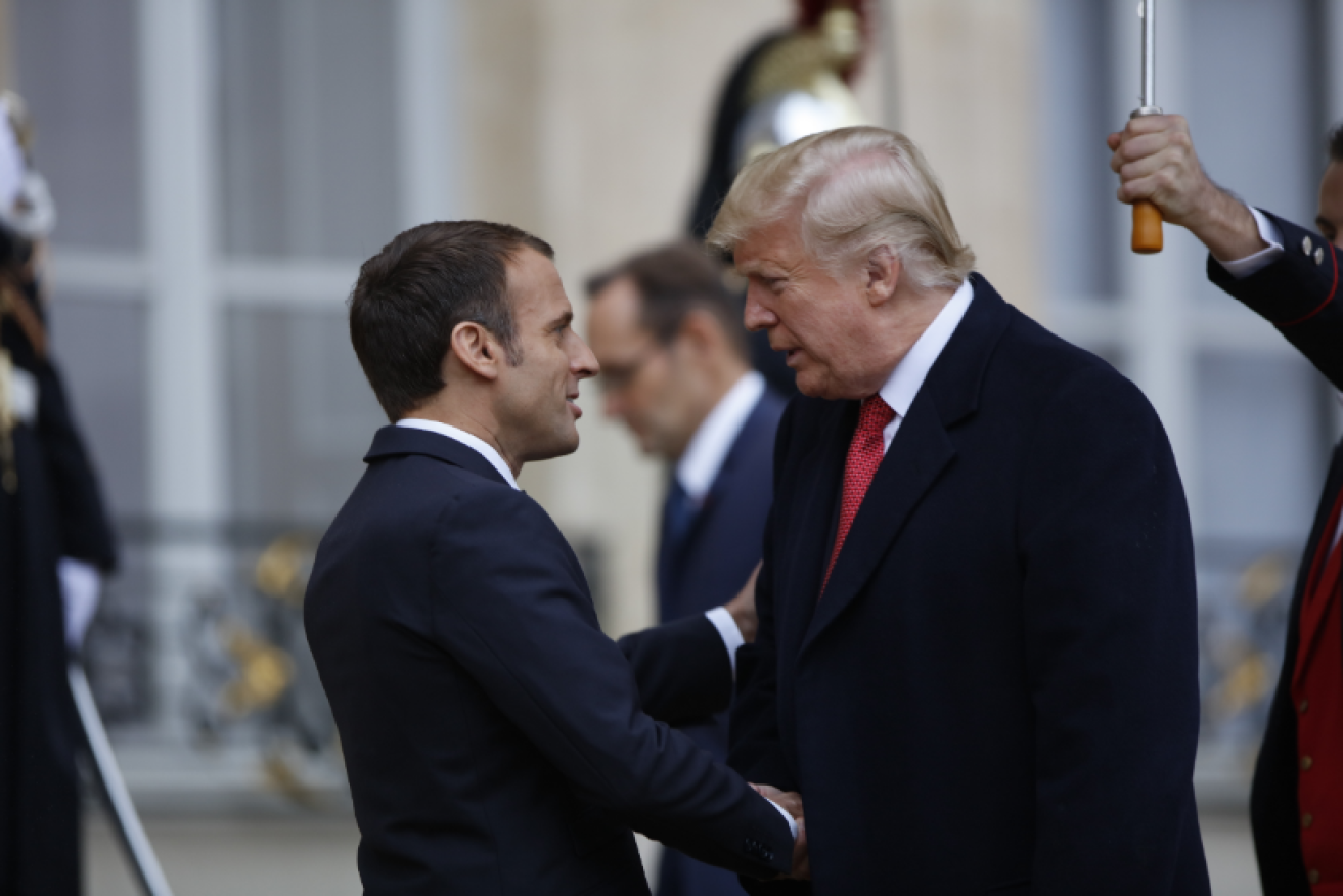 A little rain stopped Donald Trump, but not Emmanuel Macron, attending a memorial for soldiers killed on the Western Front.