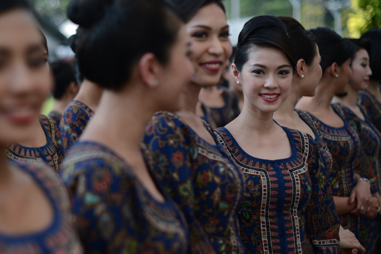 Singapore Airlines' cabin crew (in 2014) wear signature sarong kebaya uniforms created by Pierre Balmain in 1968.