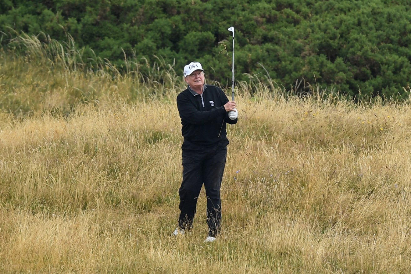 Donald Trump has been accused of using his caddie to cheat.