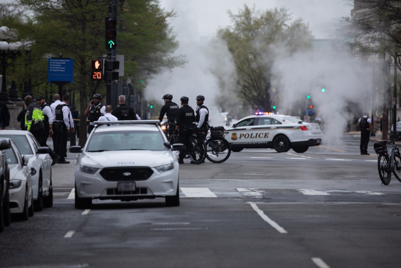 Police arrive at the scene after a man lit himself on fire near the White House in Washington DC.