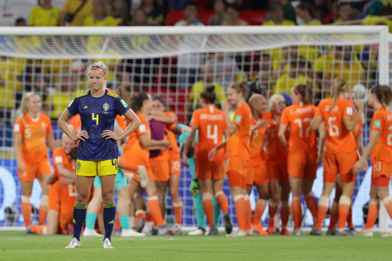 Sweden's Hanna Glas is deflated as the Dutch celebrate reaching the final.
