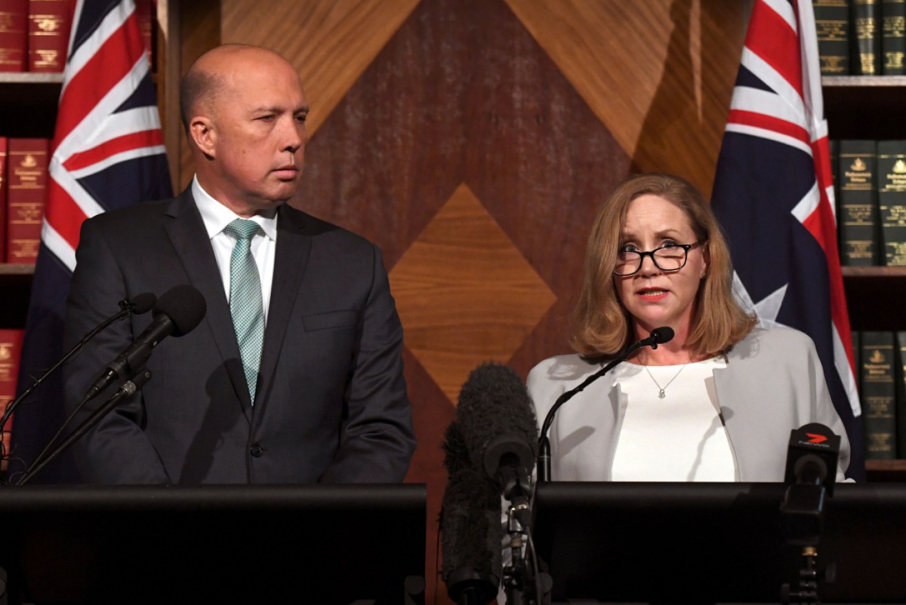 Australian Transaction Reports & Analysis Centre chief executive Nicole Rose, right, pictured with minister of home affairs, immigration, and border control Peter Dutton.