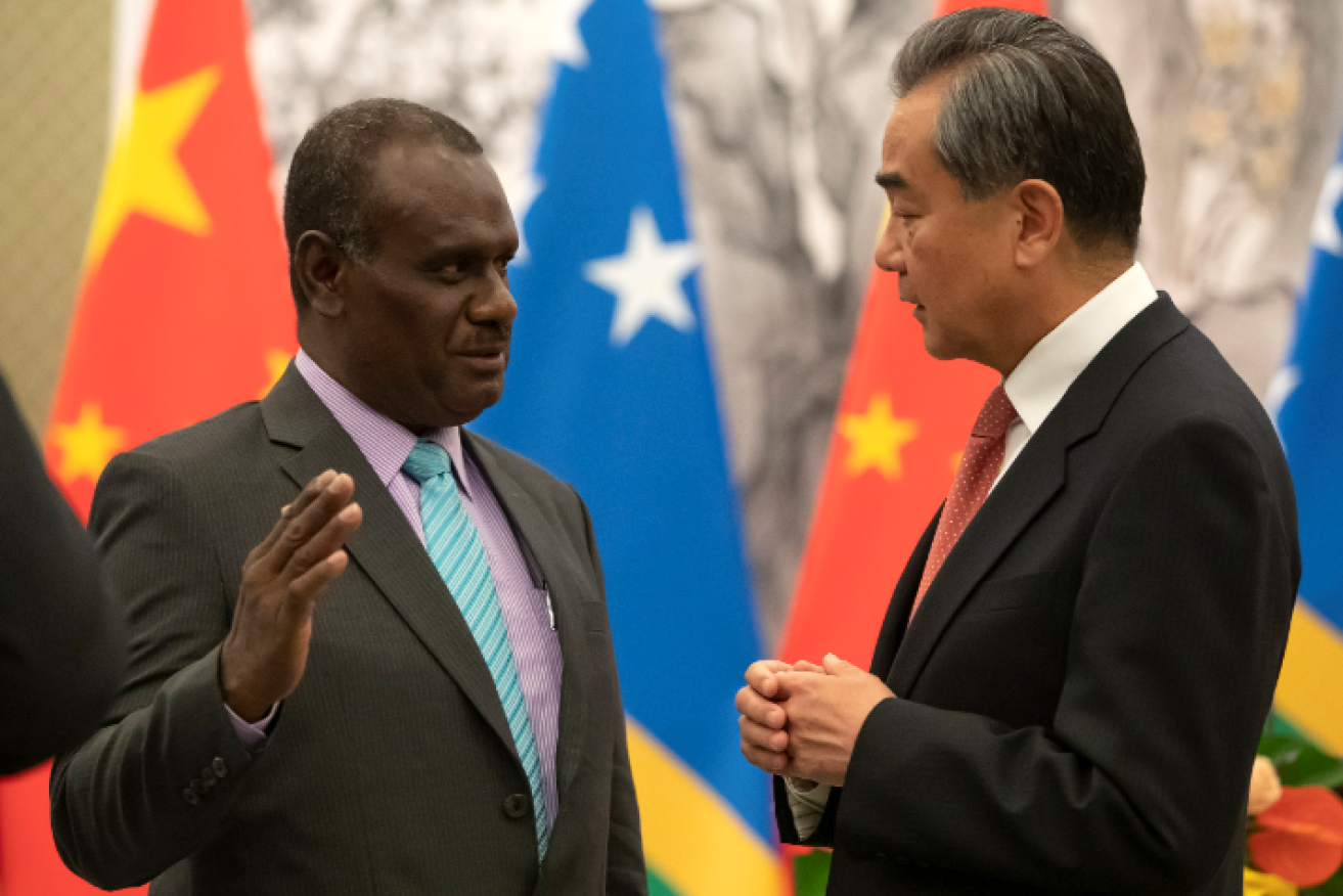 Solomon Islands Foreign Minister Jeremiah Manele, and Chinese Foreign Minister Wang celebrate the establishment of diplomatic relations.