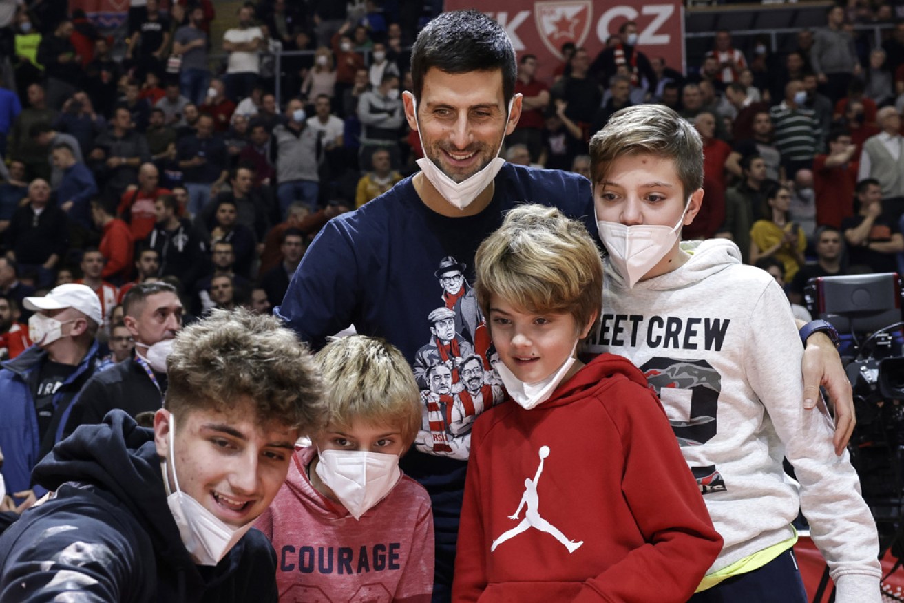 Novak Djokovic at a basketball game in Serbia in December – a day after he says he tested positive to COVID.