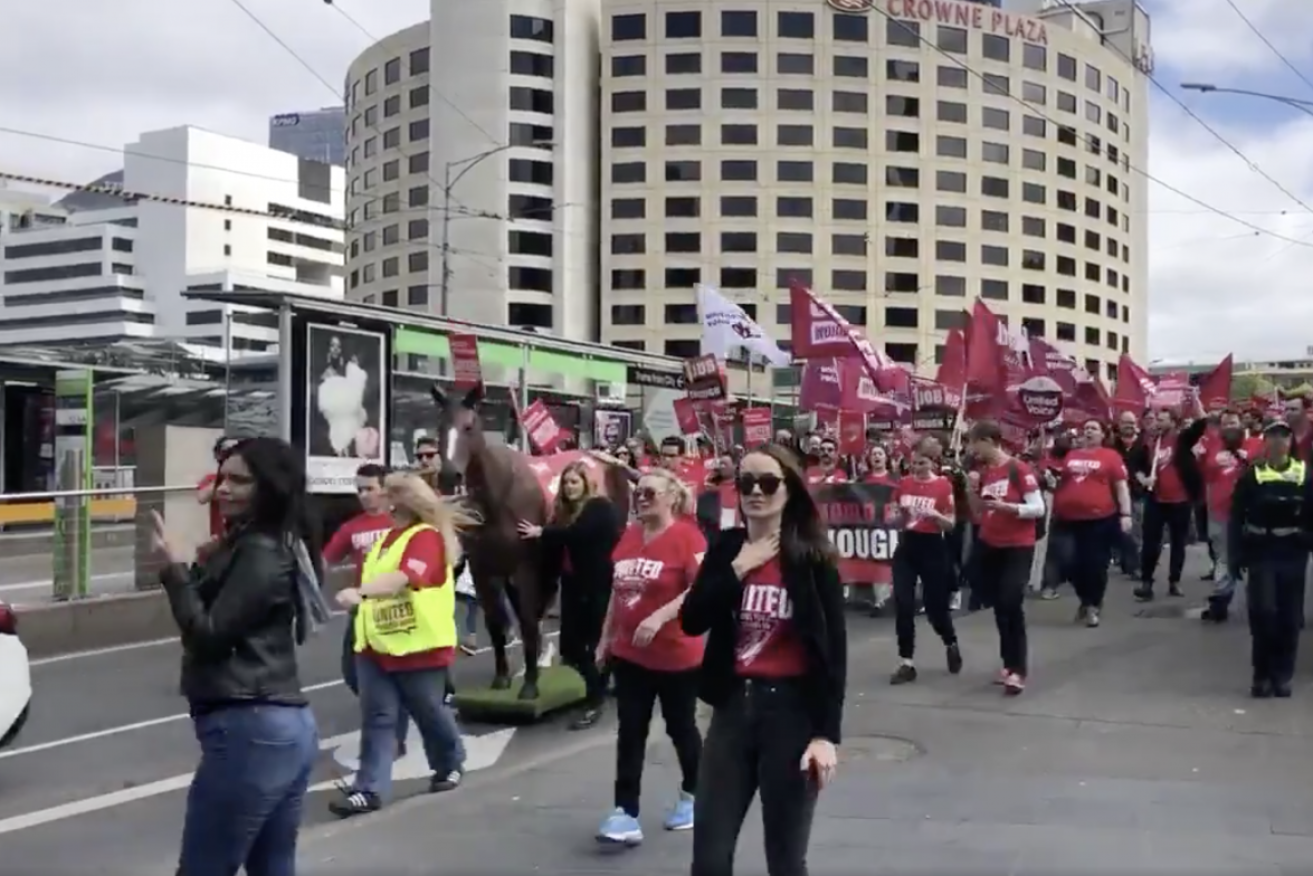 About 1000 Crown staff and supporters marched on the Crown casino and workers are in the final stages of a ballot on whether to strike.