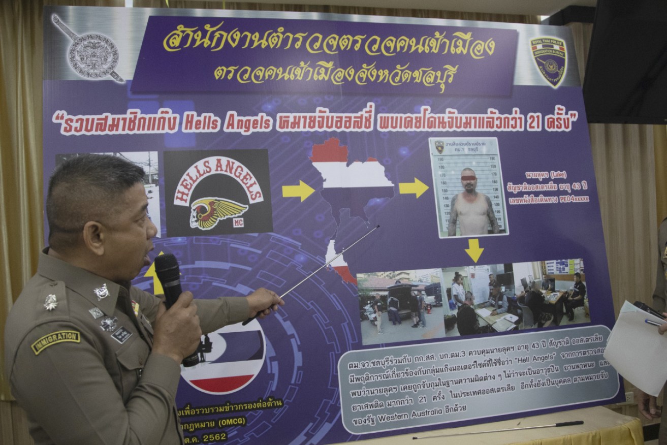 An immigration officer uses a timeline information board describing details of Australian national Luke Anderson during a press conference at the Immigration Bureau in Bangkok, Thailand, Monday, Oct. 28, 2019.