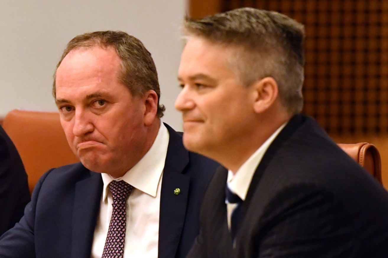 Mathias Cormann (right) doesn't believe Barnaby Joyce will follow through on his threat to cross the floor.