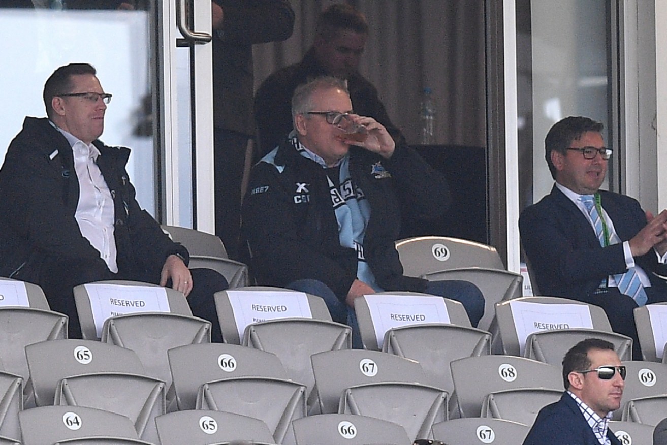 PM Scott Morrison drinking a beer and cheering on the Cronulla Sharks.