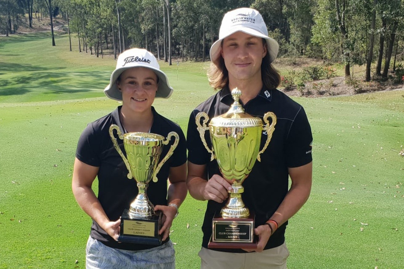 Ash Barty, the 2020 Brookwater Golf Club's female champ, with male champ Louis Dobbelaar.