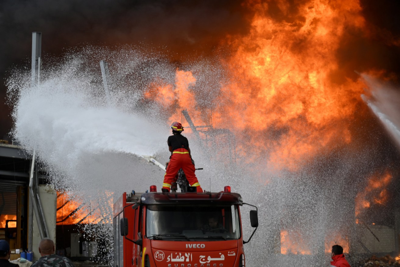Lebanese firefighters try to extinguish a fire at Lebabnon's Port of Beirut on Thursday.