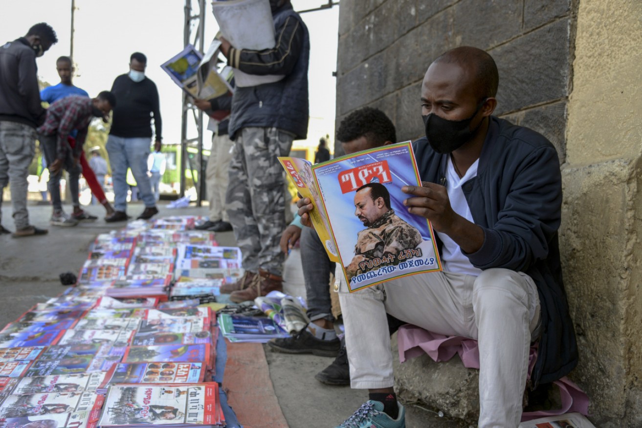 Ethiopians read about the military confrontation in the country on a street in Addis Ababa.