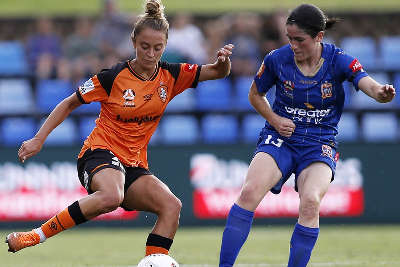 Brisbane's Isobel Dalton takes on Newcastle’s Lauren Allan in Sunday evening’s W-League match in Newcastle.
