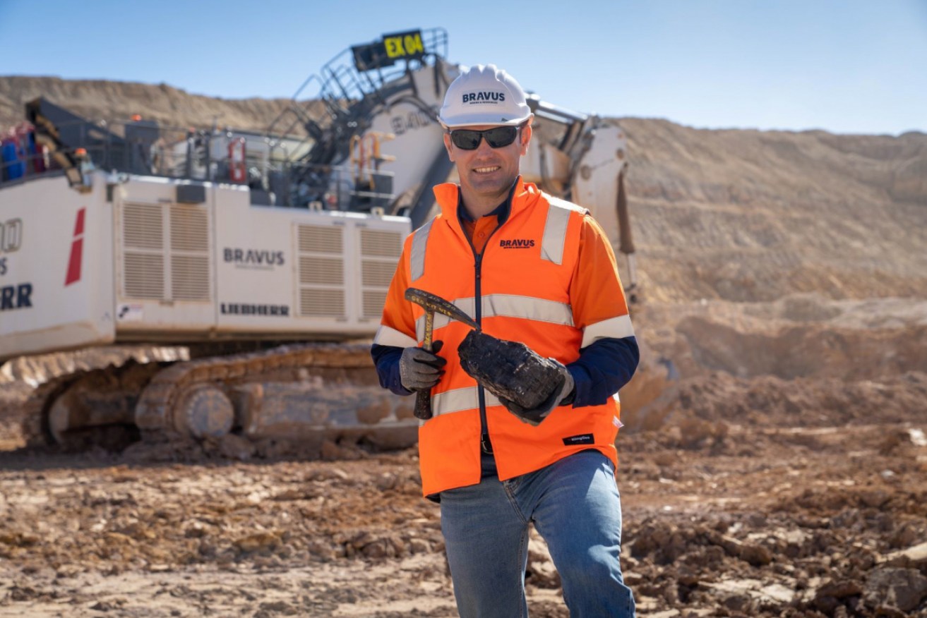 David Boshoff, CEO of Bravus Mining, holds a lump of coal at the Carmichael mine project. 