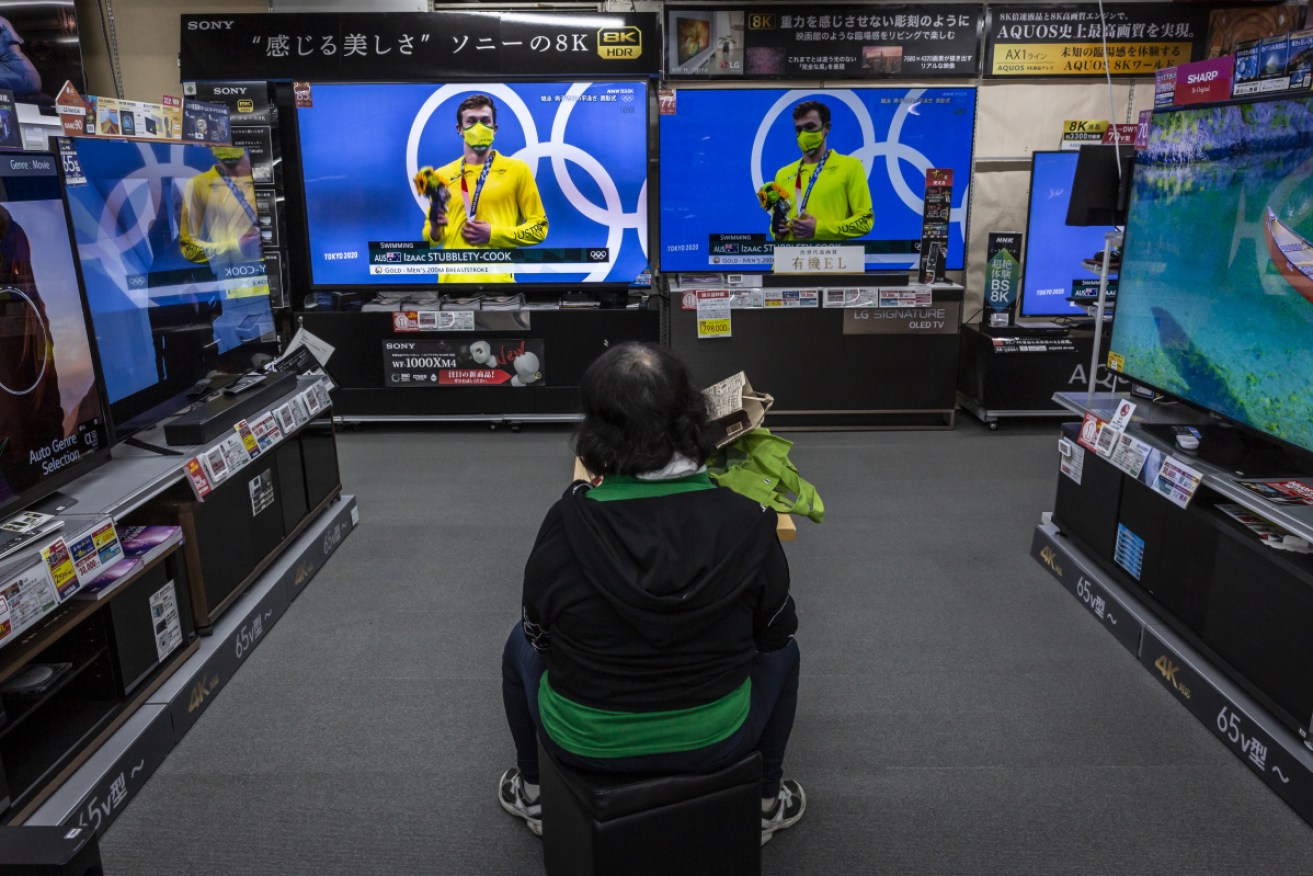 This woman has her choice of screens in a Tokyo electronics store – but around the world people are tuning out.