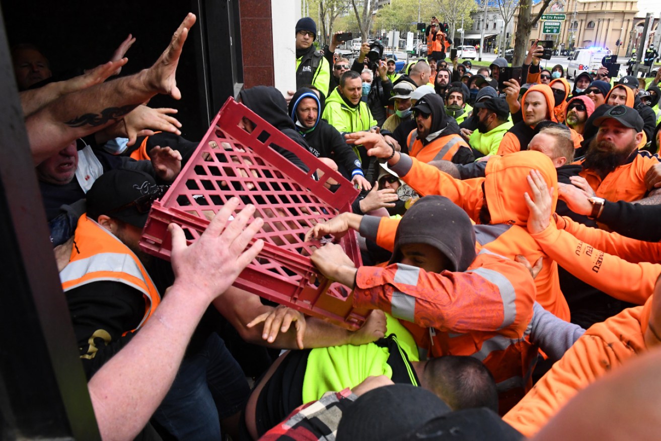 Bottles and bread crates were hurled in an angry confrontation between workers at CFMEU officials in Melbourne on Monday.