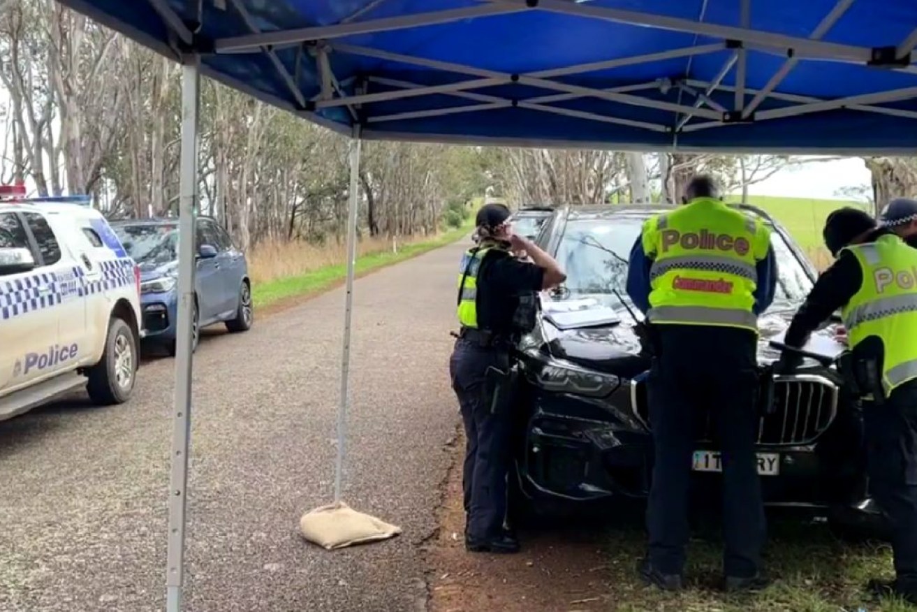 Police at the scene on Wannon-Nigretta Falls Road, Bochara, Victoria.