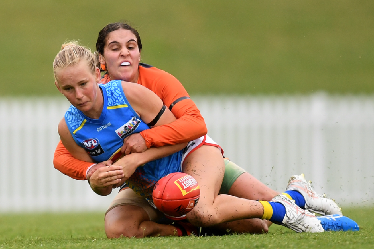Haneen Zrekia, shown here in 2021 laying a tackle on the Suns' Daisy D’Arcy, refused to play in a Rainbow jumper.
