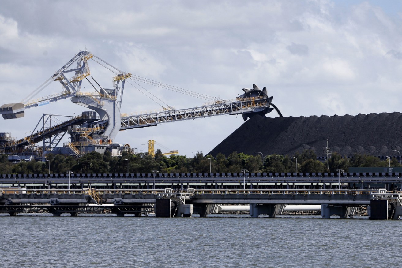 Coal stockpile and reclaimer at Kooragang Coal Loader in the Port of Newcastle.