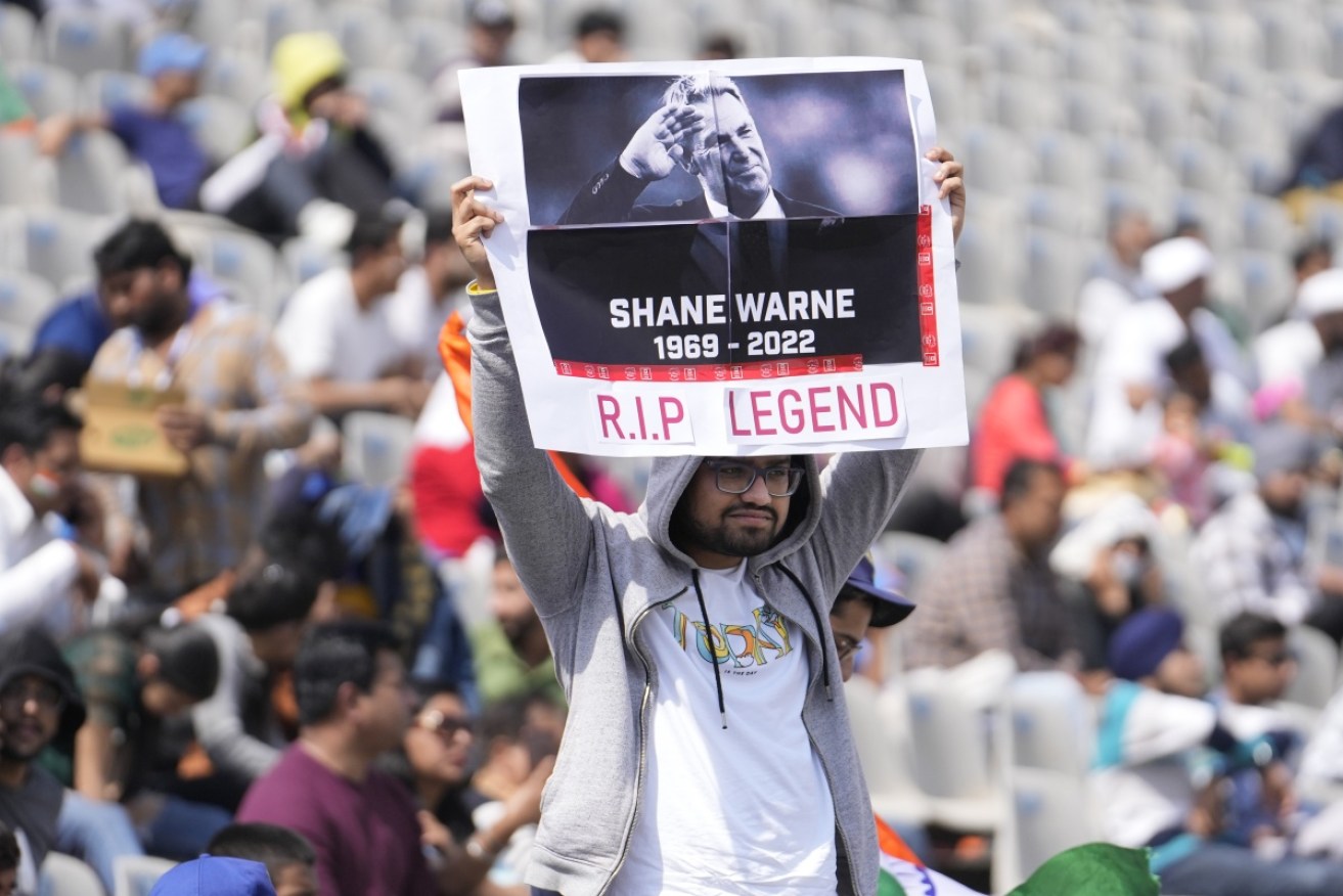 A fan holds tribute to Shane Warne on the third day of the first Test match between India and Sri Lanka in Mohali, India.