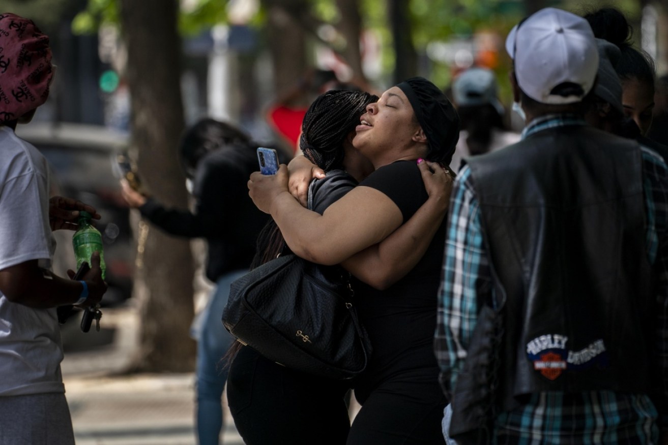 Victims' families comfort each other at the scene of the shooting in downtown Sacramento.