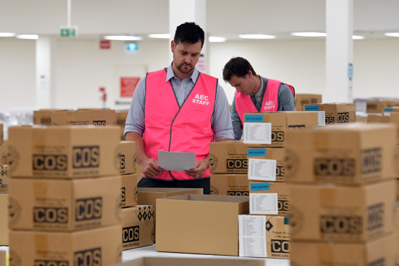 The AEC's Evan Ekin-Smyth inspects voting materials at a warehouse in Queanbeyan, near Canberra.