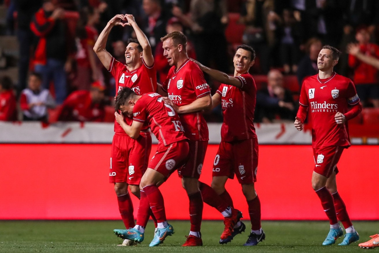 Javi Lopez celebrates his goal with teammates in Adelaide United's 2-1 win over Western United. 