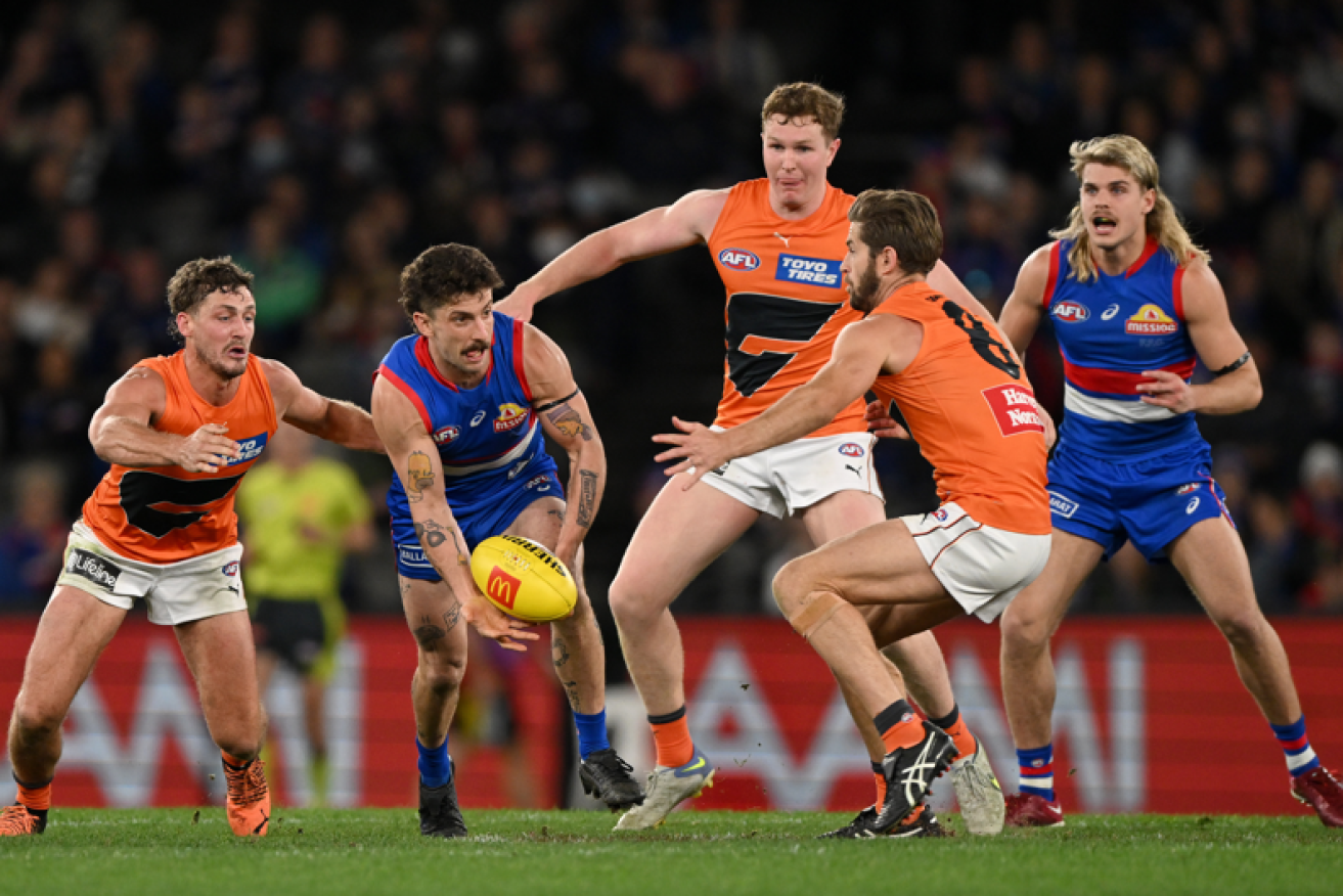 Tom Liberatore shovels the ball out of the pack as the Bulldogs kept their September dreams alive. <i>Photo: AAP</i>