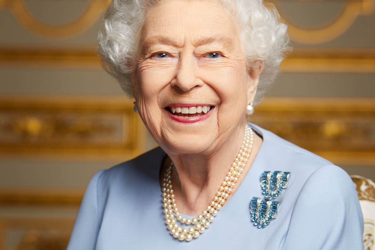 A previously unseen portrait of the Queen shows the monarch beaming brightly at the camera in her Windsor Castle home. 