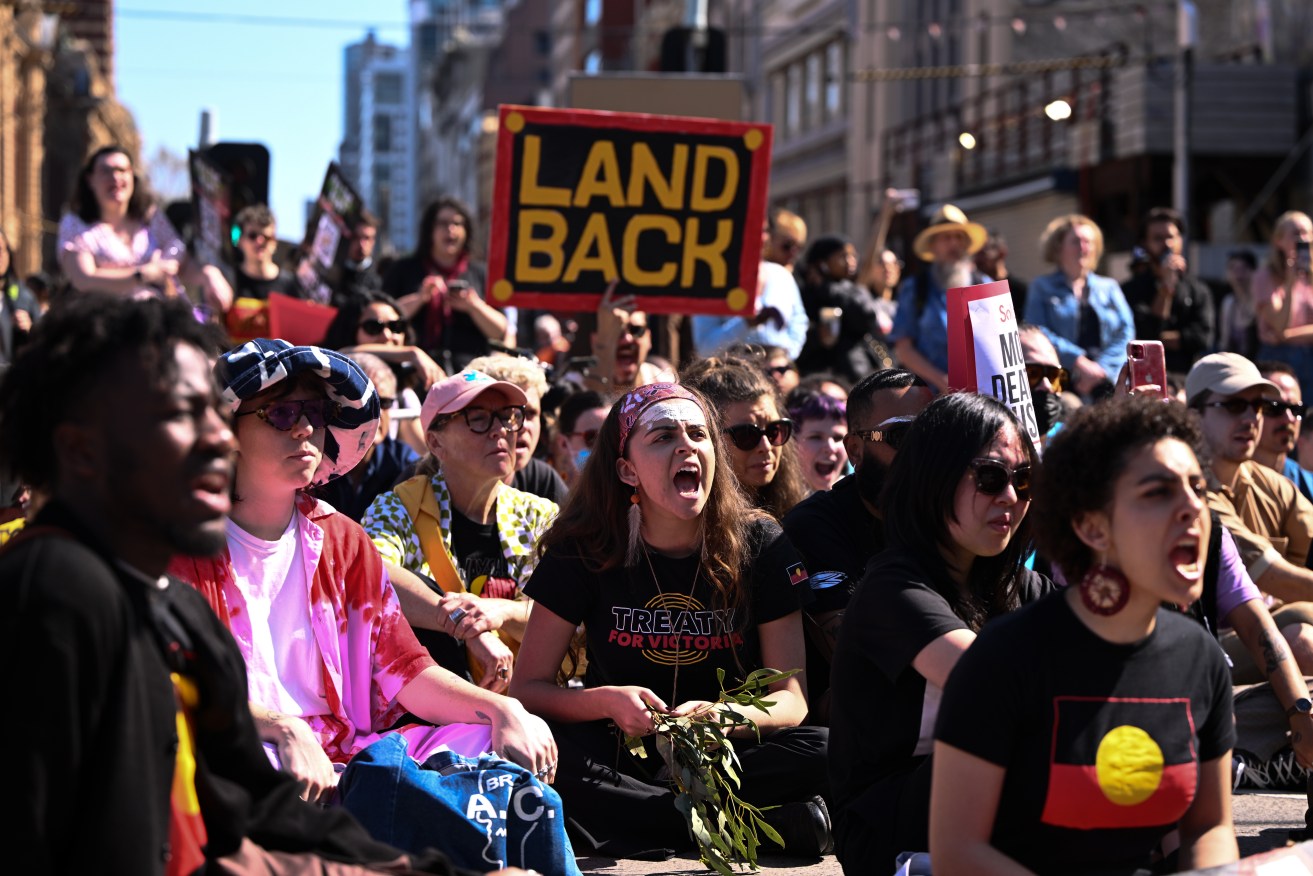 People participate in an anti-monarchy protest in Melbourne, Thursday, September 22, 2022. (AAP Image/Joel Carrett) NO ARCHIVING