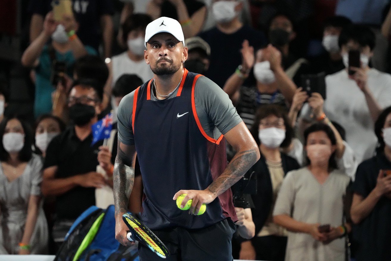 Nick Kyrgios has overcome breathing issues in the humid conditions, to win his first round match at the Japan Open.