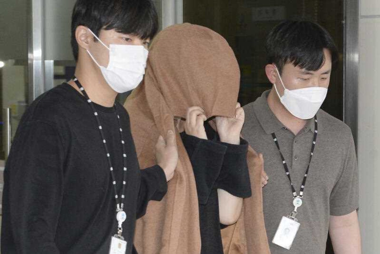 A 42-year-old Korean woman [centre] faces murder charges in NZ over the deaths of two children.